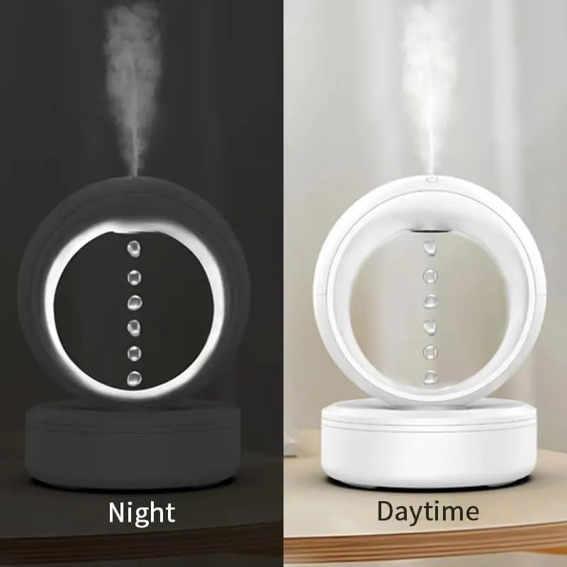 White round anti-gravity air humidifier with levitating water droplets on a desk