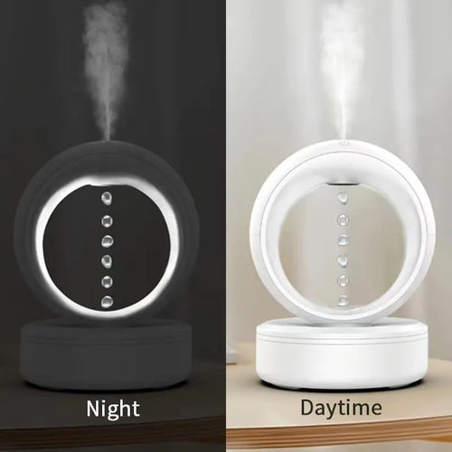 White round anti-gravity air humidifier with levitating water droplets on a desk