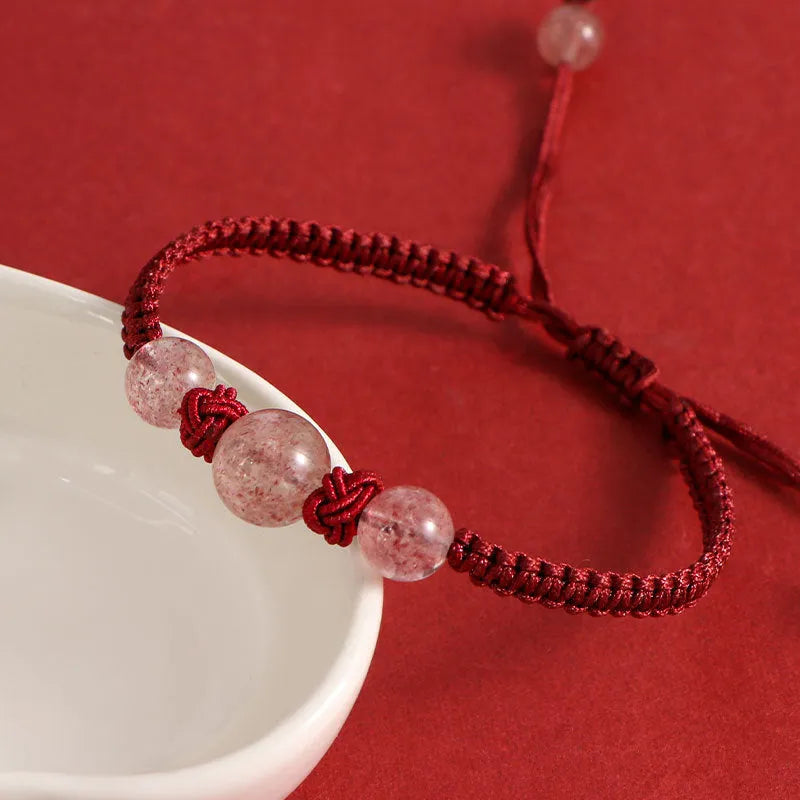 Red woven rope bracelet with spherical strawberry quartz beads and alloy accents