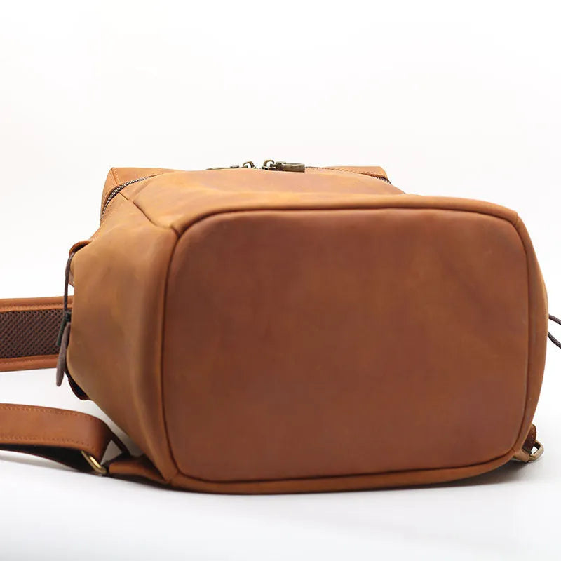 Classic retro backpack in brown Crazy Horse leather with exposed stitching and metal buckles