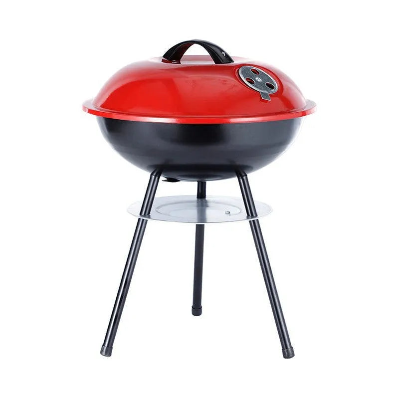 A portable 14-inch diameter iron barbecue grill with an Apple Stove design, shown on a garden patio.