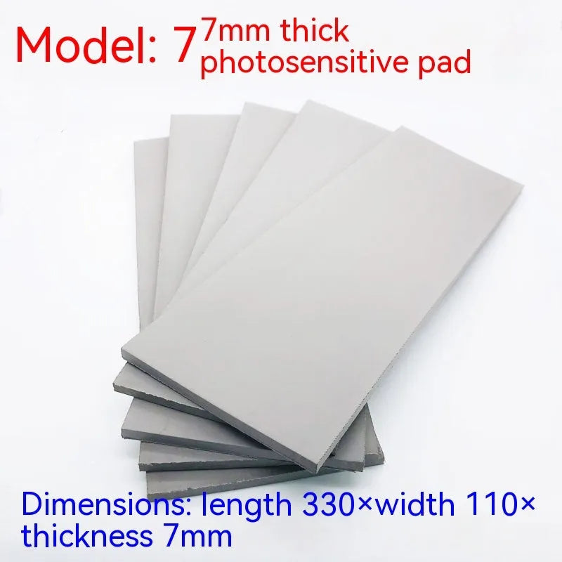 Black and grey plastic light-sensitive mat for calligraphy seals, showing 330mm by 110mm size.