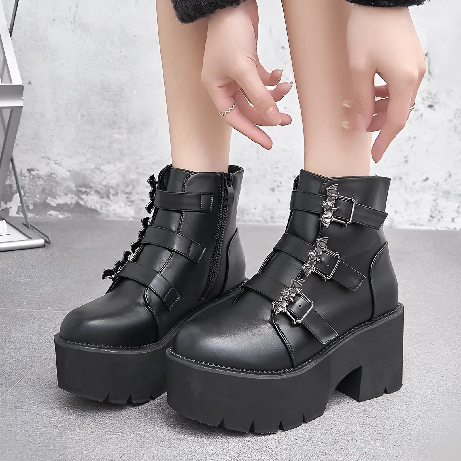 Black women's punk platform ankle boots with bat buckle and side zip.
