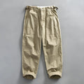 Men's straight fit cotton casual trousers in apricot, shown on a hanger.