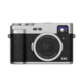 Black and brown 5K digital camera with dual lenses, a 2.88-inch screen, and an optical viewfinder on top.