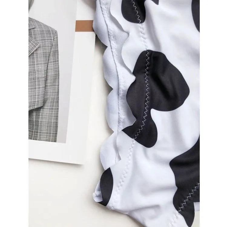 Black and white cow print wrapped breast bikini set on a model, nylon fabric, black and white animal pattern, adjustable wrap front top