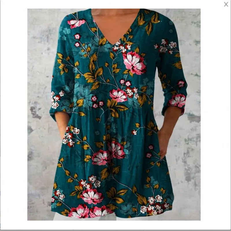 A loose-fitting women's dress with a wave print, 3/4 sleeves, and a wide waist.