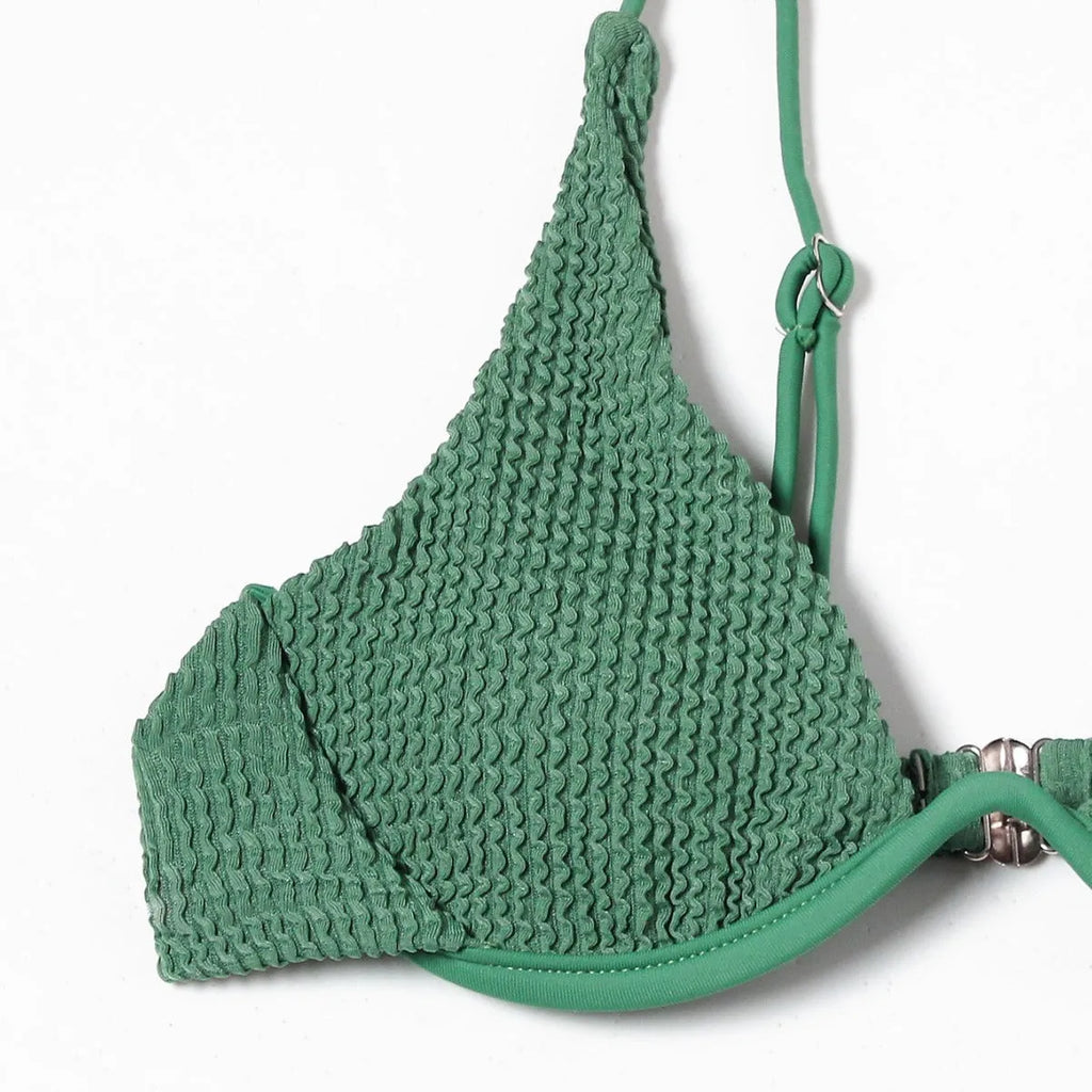 Women's solid green bikini suit with ruffle trim and split leg briefs on a mannequin.