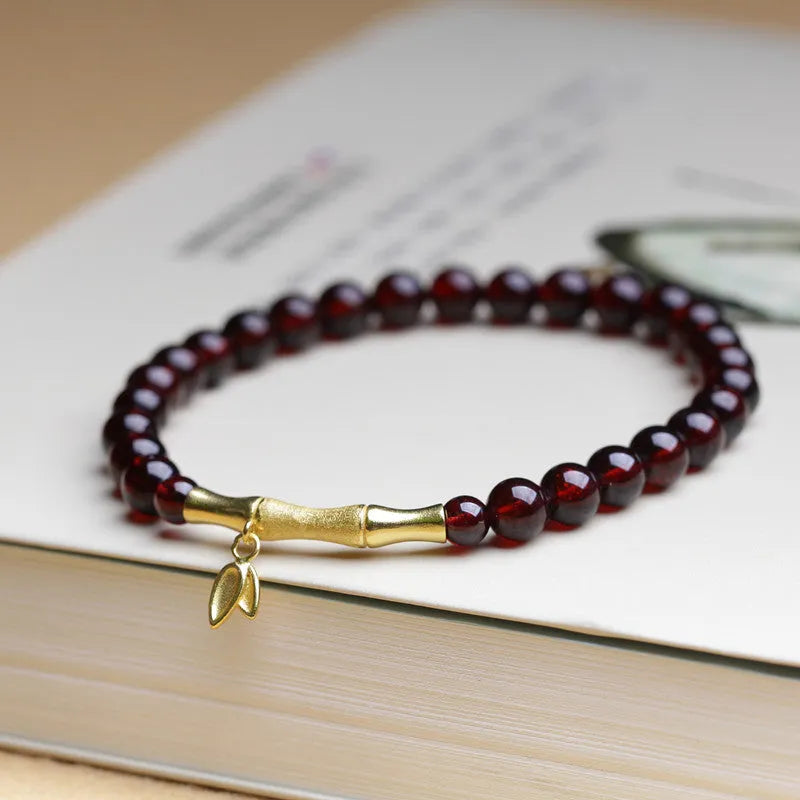 Handmade natural garnet bracelet with a 6mm silver or copper bamboo joint centrepiece.