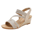 Women's gold leather platform sandals with a mid-heel on a white background.