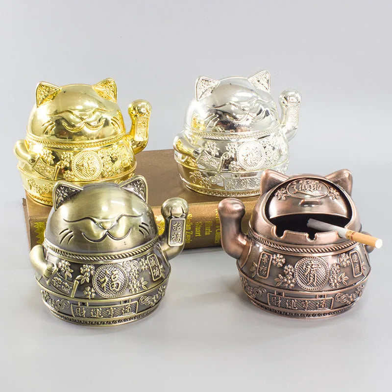 Zinc alloy lucky cat ashtray with cover in gold black colour on a wooden table