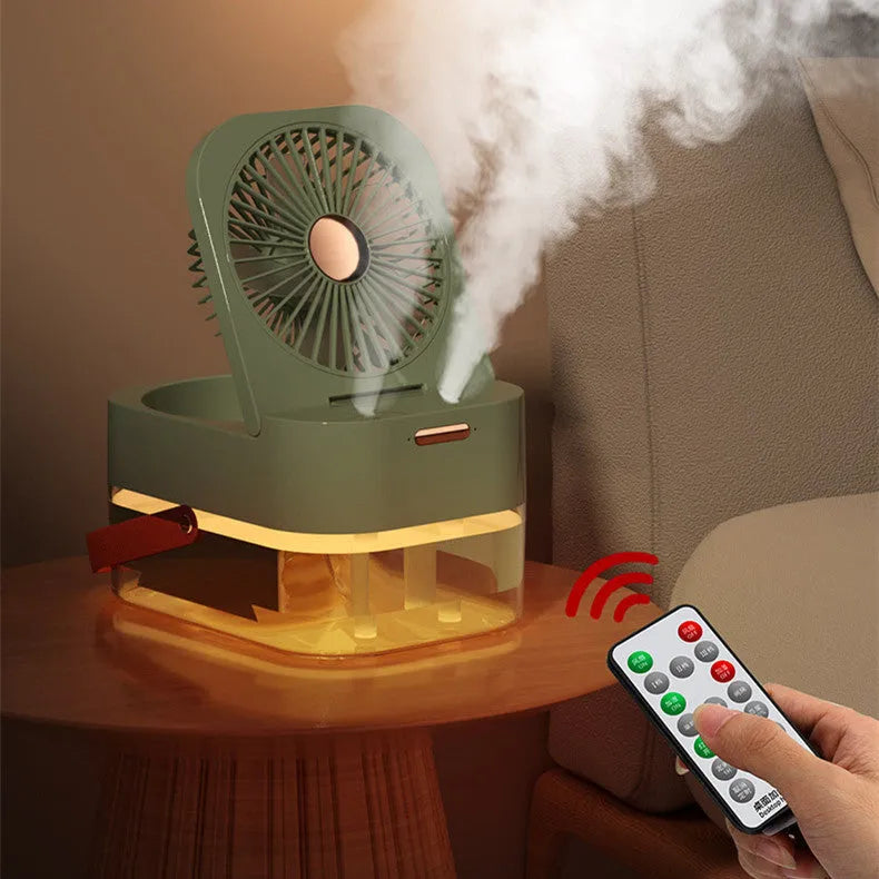 White or green USB desktop humidifier fan with remote control on a wooden desk.