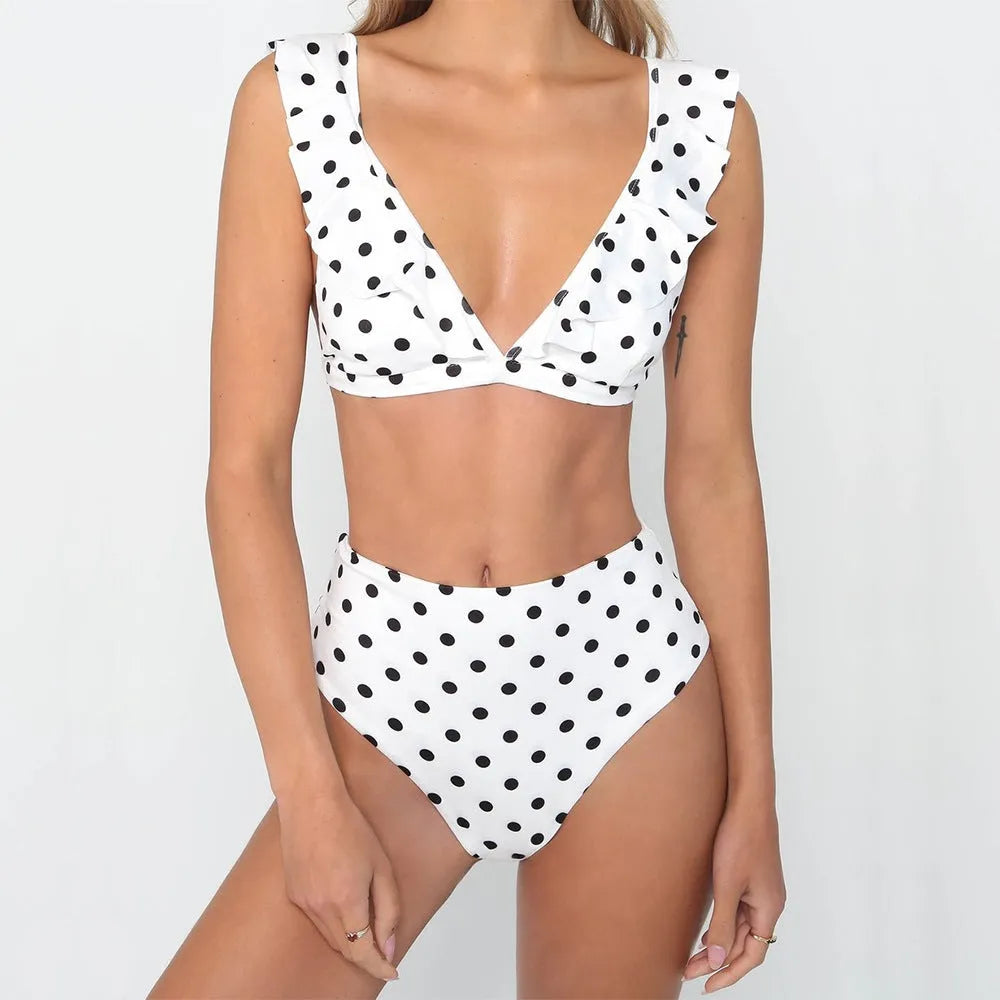 Women's black and white polka dot bikini set with ruffled deep V-neck top and matching shorts