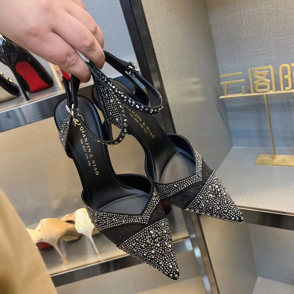 Women's silver hollow high heels with red sole and pointed stiletto heel.