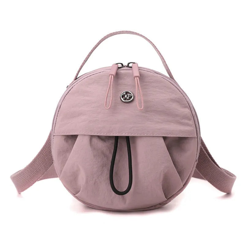 Nylon messenger crossbody bag with out shoulder design showing internal phone and document compartments