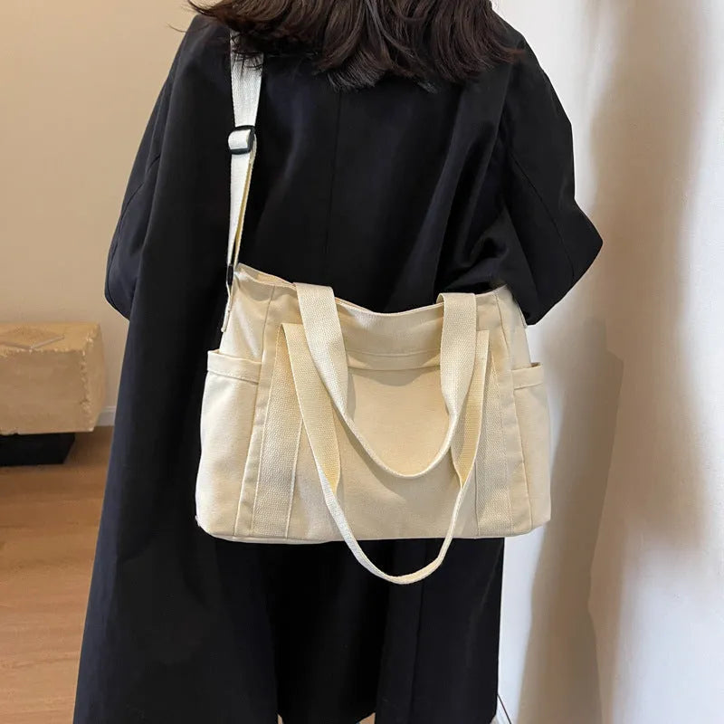 Large capacity polyester canvas shoulder tote bag with internal phone compartment in solid colour