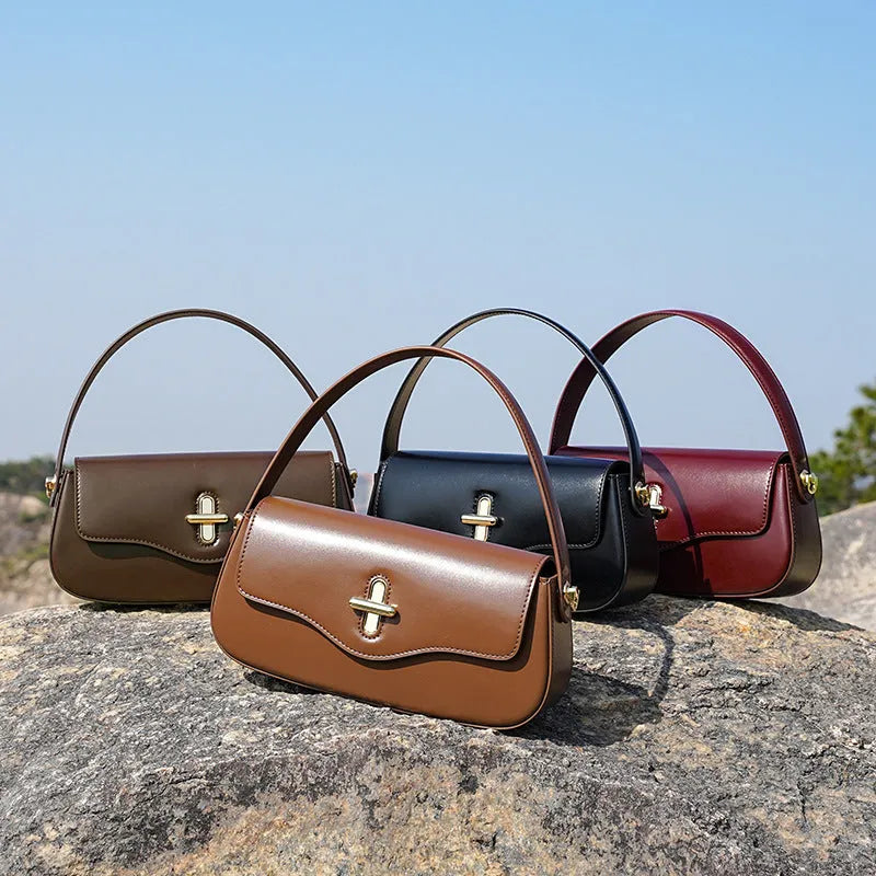 Genuine leather women's baguette handbag with lock detail and double shoulder straps