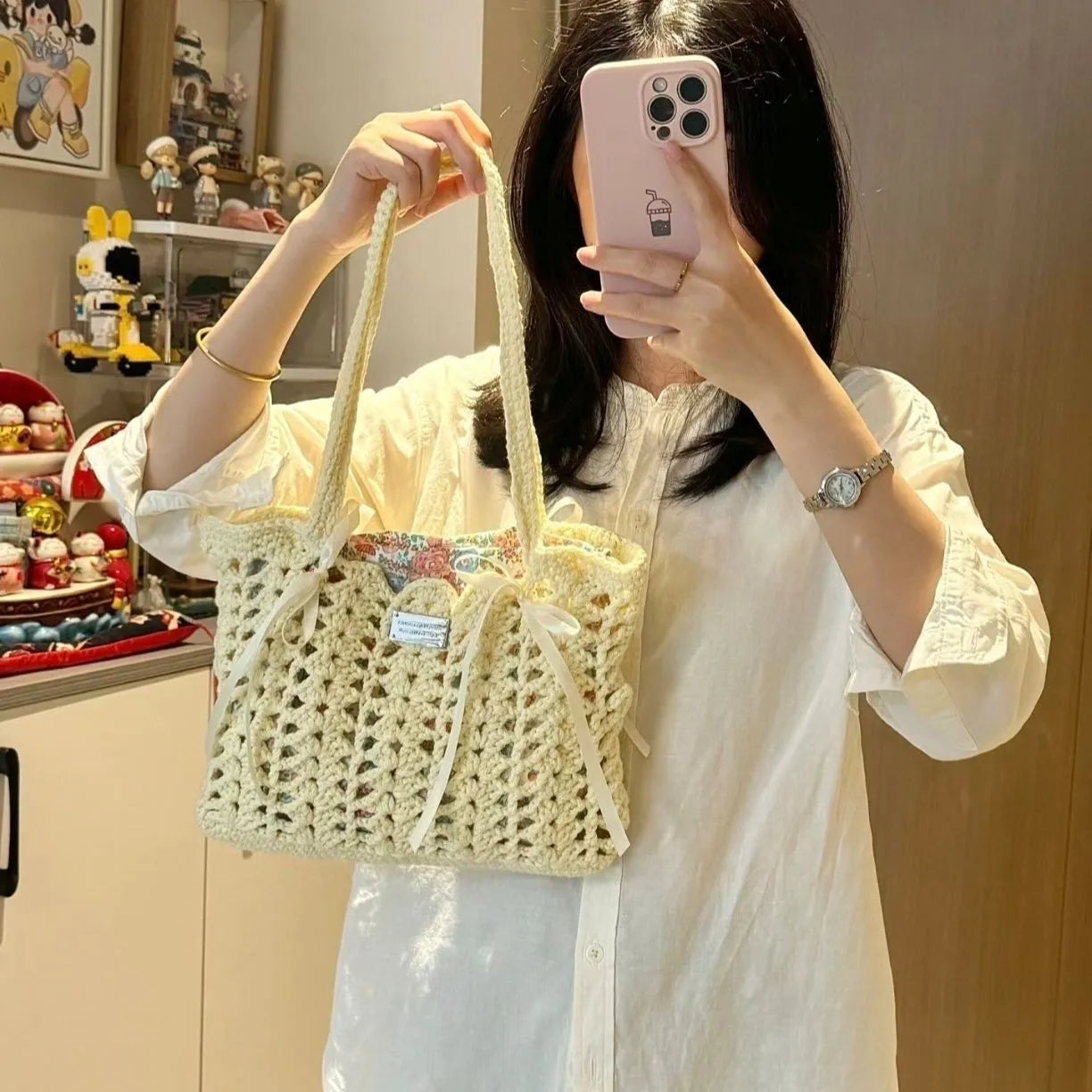 Handwoven wool summer tote bag with a floral patterned design.