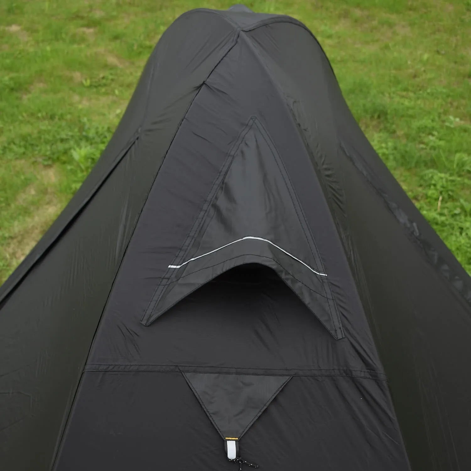 Single-person double-skin hiking tent in orange with aluminium poles, shown pitched in a field.