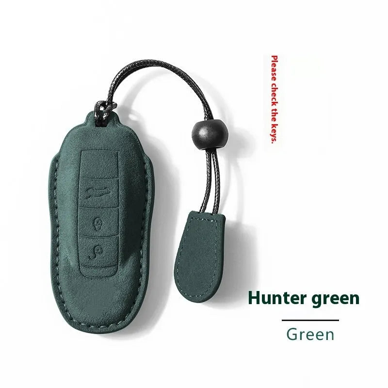 Suede car key cover in Cement Gray, Dark Green, Light Gray, and Orange colour options.