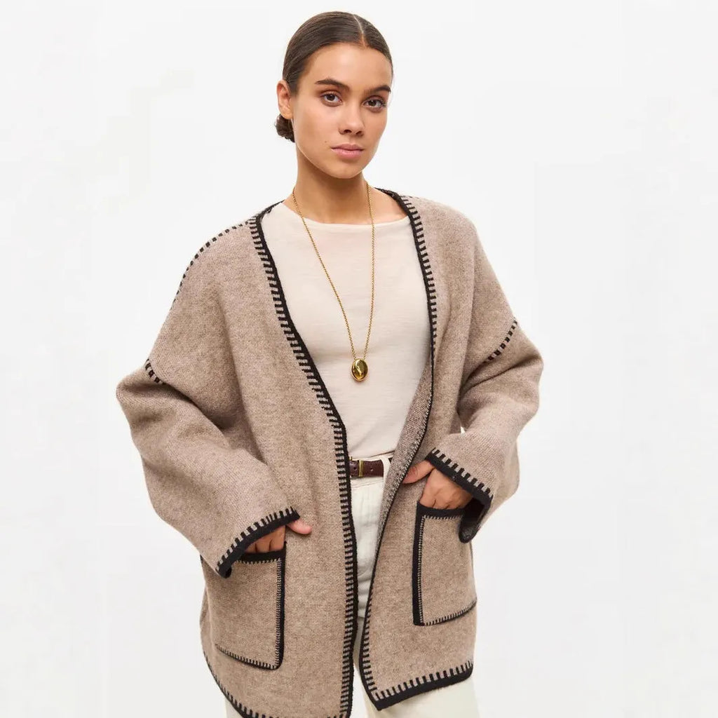 Loose lace-up knitted cardigan in camel colour, showing mid-length fit and long sleeves.