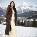 Long brown leopard print faux fur coat on a plus-size model, showing its 100cm length and loose fit.