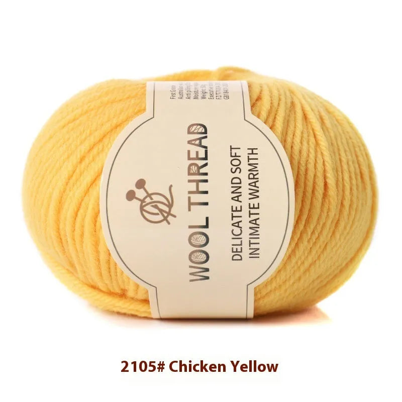 One roll of beige domestic wool hand-knitting yarn for size 10 needles next to knitting needles.