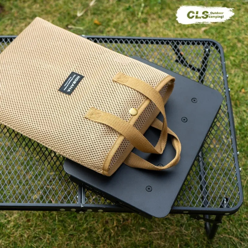 CLS aluminium dual-use folding camping stool converted into a small table next to its storage bag.
