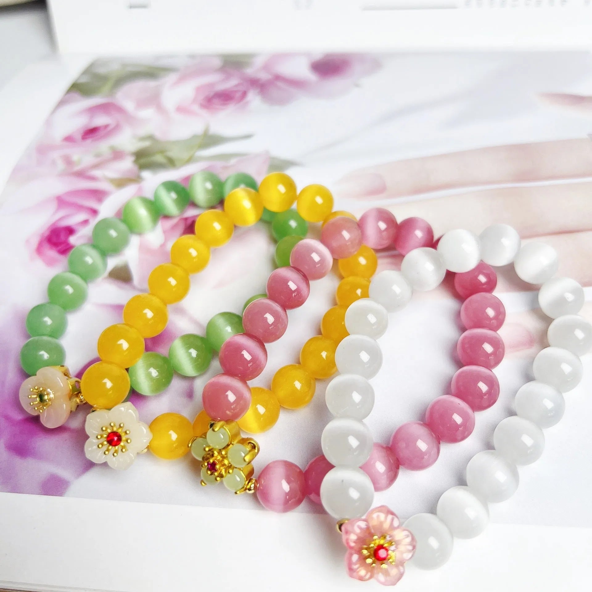 Women's handmade glass beaded bracelet with floral design in yellow, pink, white, or green colours