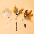 Three steel wire cat toy replacement heads shaped like small flying insects on a white background