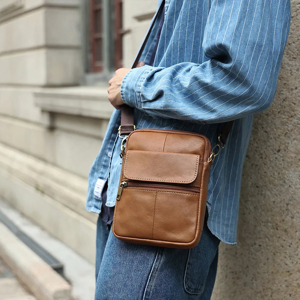 Men's brown leather crossbody shoulder bag with visible stitching and crossbody strap