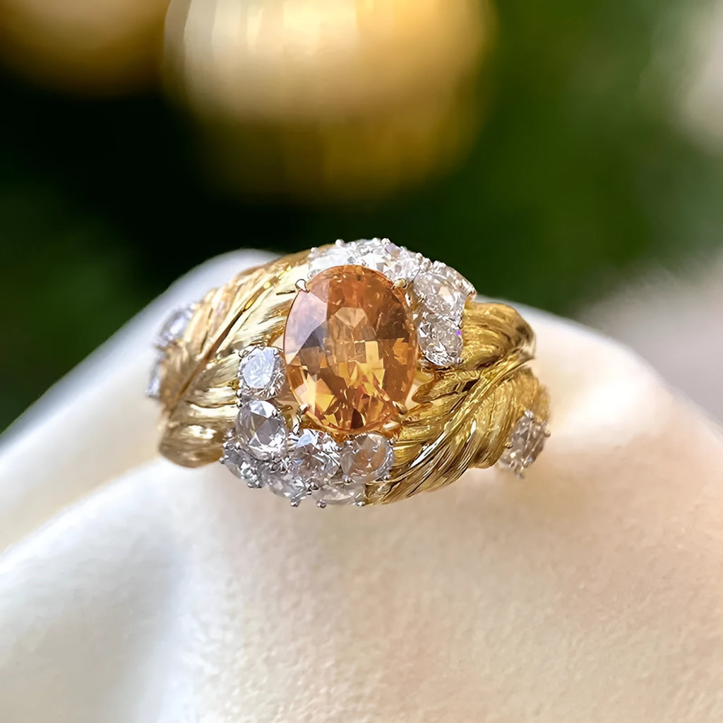 Gold-colour copper women's ring with embossed feather design and yellow zircon stone.
