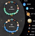 Set of twelve natural stone beaded bracelets for each zodiac sign on a flat surface.