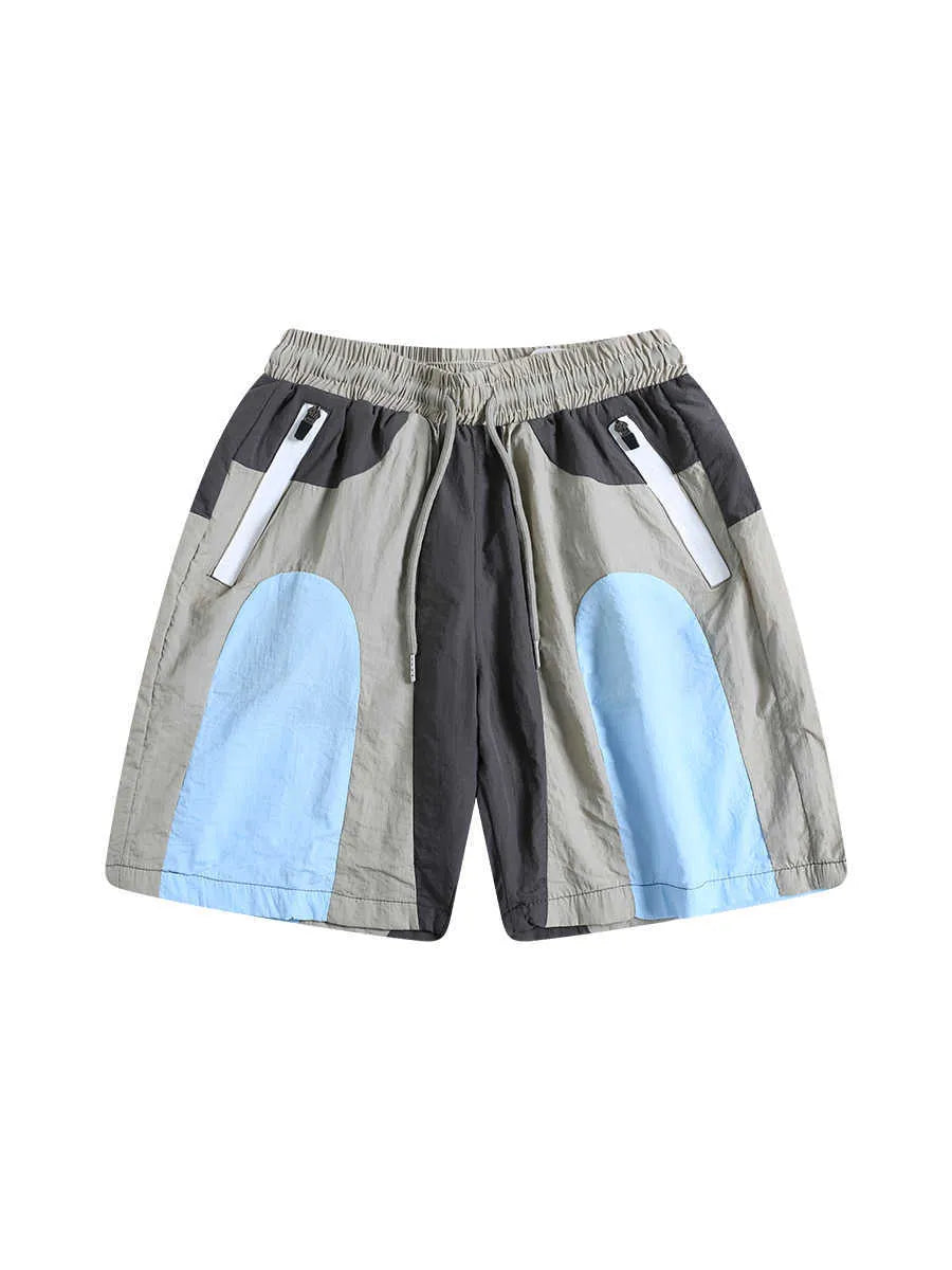 Man wearing blue patchwork loose-fit quick-drying casual sports shorts.