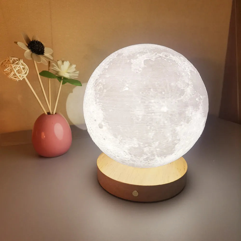 Rotating sleeping moon night lamp with wooden base showing three colour settings