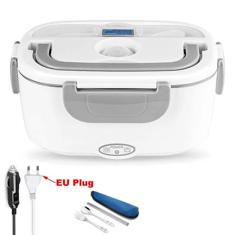 Grey dual voltage electric lunch box with plastic body shown next to a car socket and mains plug