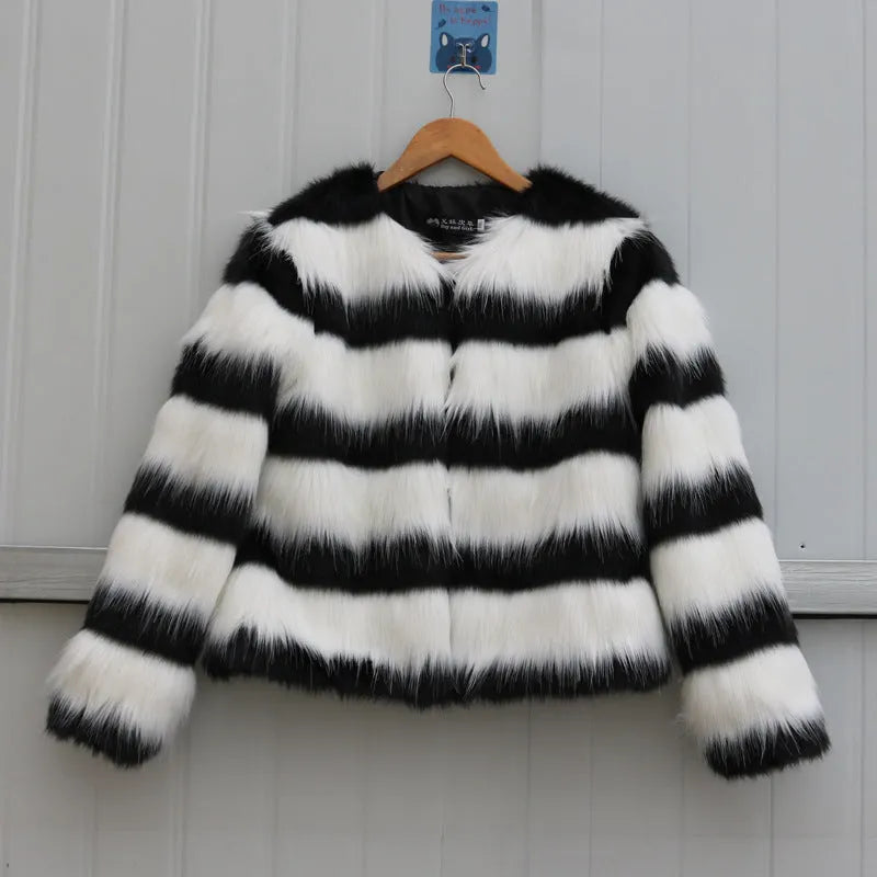 Women's long-sleeved black and white striped faux fur leather jacket on a hanger.