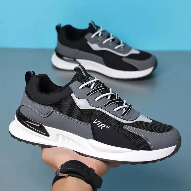 Men's black and grey colour block mesh running shoes with white soles on a plain background.