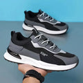 Men's black and grey colour block mesh running shoes with white soles on a plain background.