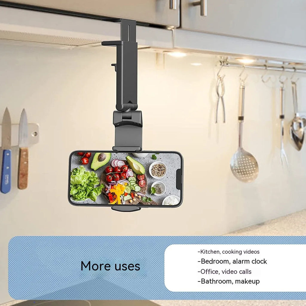 A black foldable phone holder with a rotating base, shown holding a mobile phone in landscape orientation.