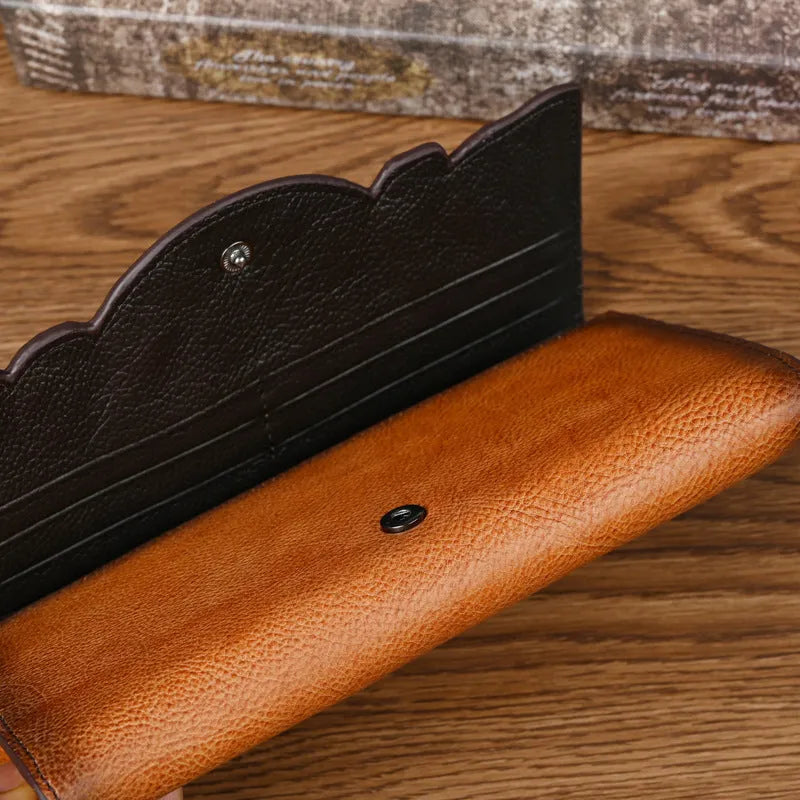 Retro brown tri-fold women's leather wallet with an embossed floral pattern, shown open to reveal compartments.