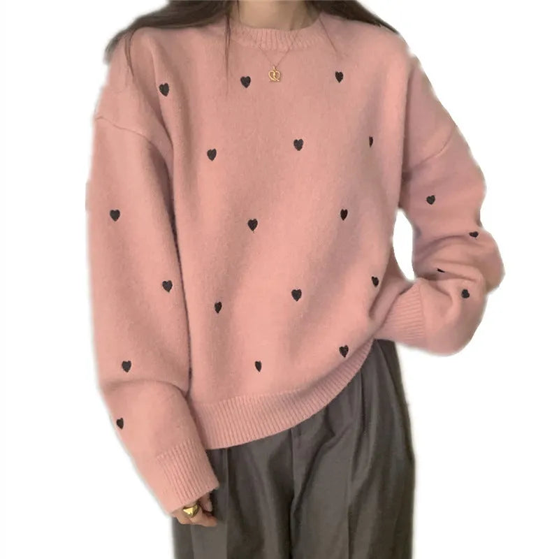 Women's loose grey acrylic pullover sweater with embroidery on the chest.
