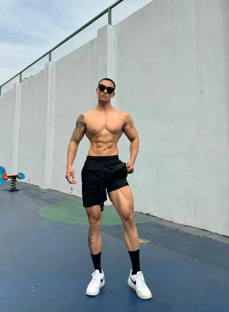 Men's ice silk quick-drying double-layer casual shorts in black, shown on a model.