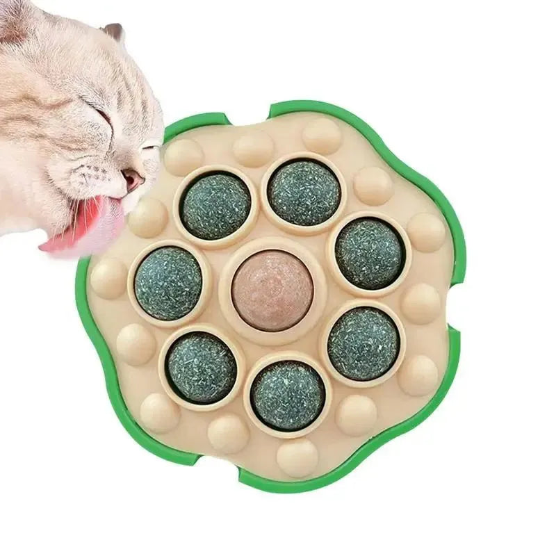 Green wall-sticking catnip ball with edible filling for indoor feline play and dental care