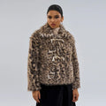 Women's leopard print coat with a buckle on the lapel collar, shown in street fashion style.