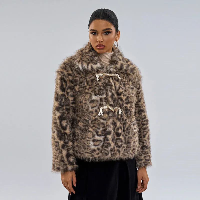 Women's leopard print coat with a buckle on the lapel collar, shown in street fashion style.