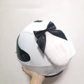 Carbon fibre rabbit ears motorcycle helmet decoration in black with a bow, shown on a helmet.