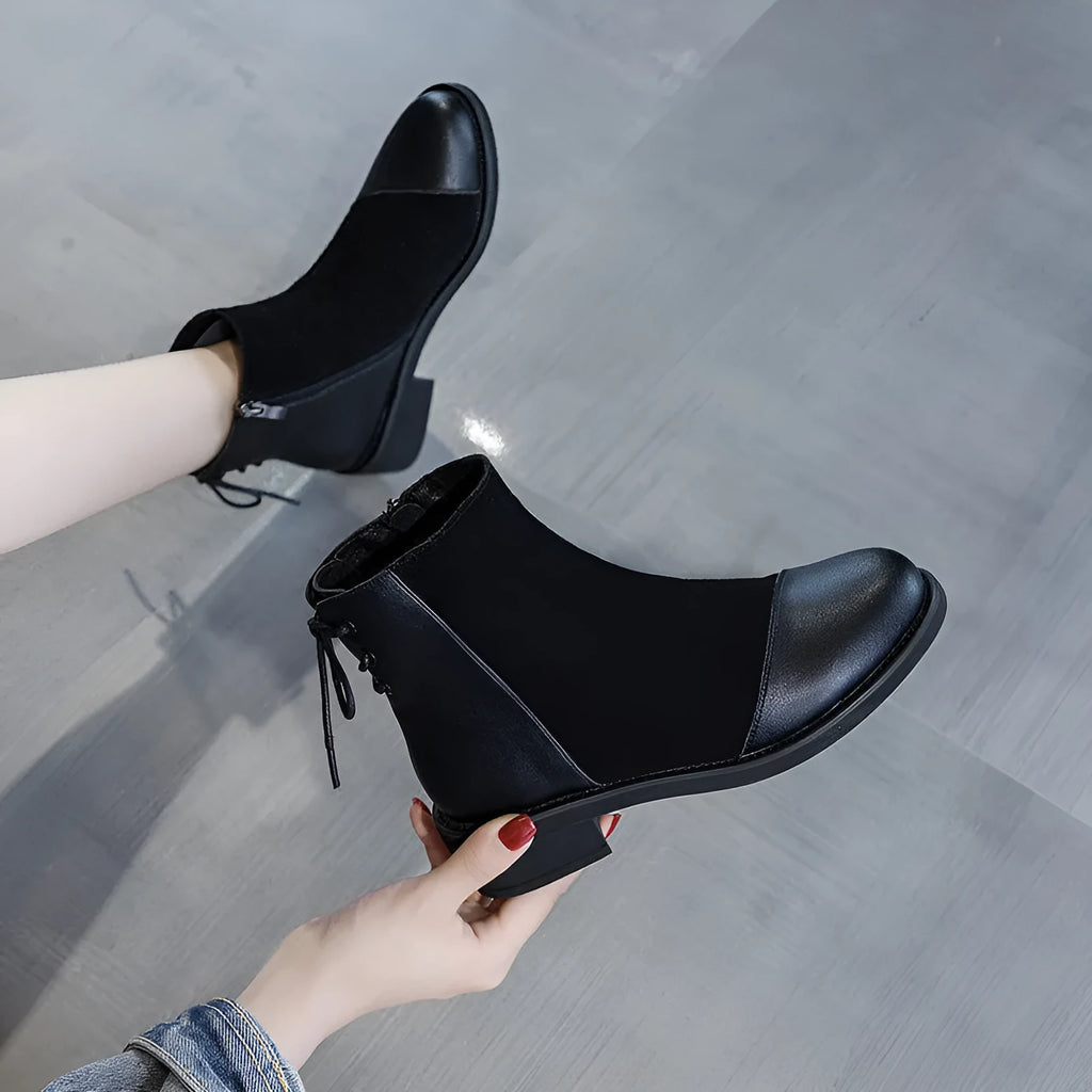 Black women's knee-high Martin boots with side zip and a decorative bow.