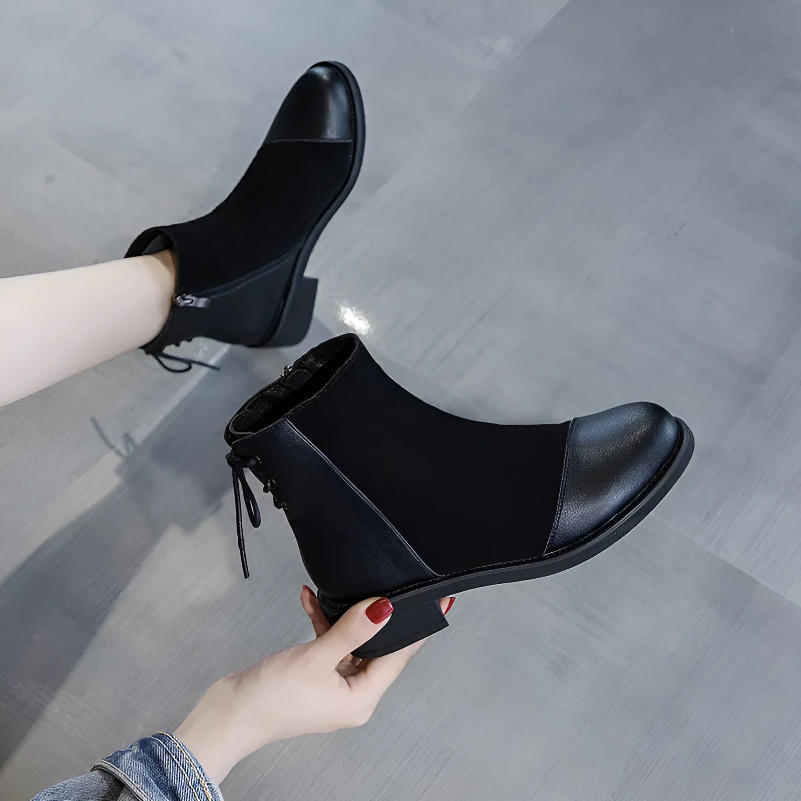 Black women's knee-high Martin boots with side zip and a decorative bow.