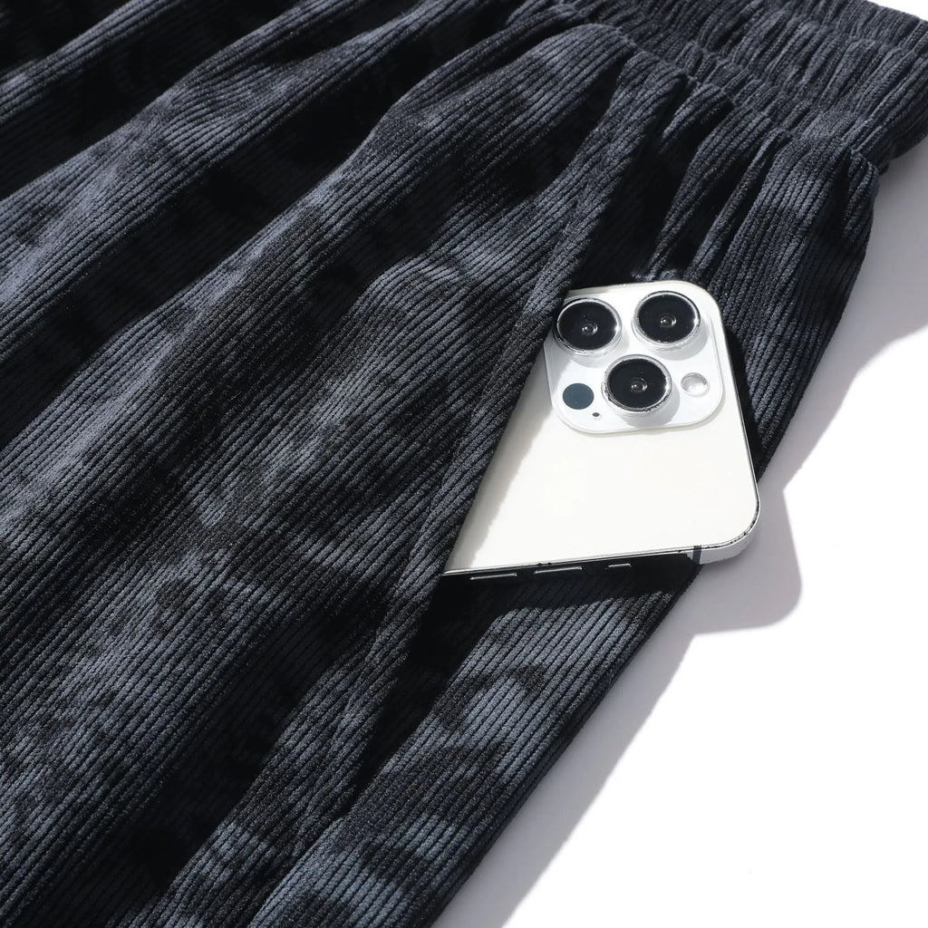 Men's camouflage pattern athletic shorts in polyester corduroy fabric showing straight cut design